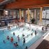 Hotel Stadt Mühlhausen indoor pool with guests, floor-to-ceiling windows and sauna area in Mühlhausen