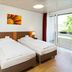 Bildungshaus St Bernhard in Rastatt: twin room with two single beds and window view