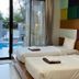 Chalay Monta in Hua Hin guest room with twin beds and a pool view through sliding glass doors