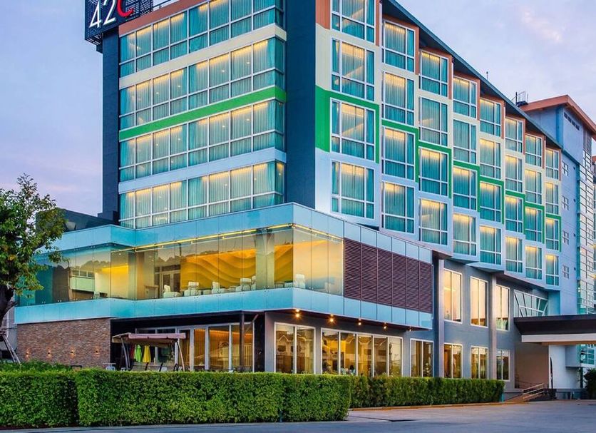 42C The Chic Hotel in Nakhon Sawan, modern glass-front hotel exterior at dusk