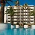 AC Hotels by Marriott Ambassadeur Antibes- Juan les Pins pool with palm trees and hotel facade in Antibes