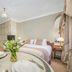 44 Curzon Street by Mansley, London guest room with king bed, round table, and floral arrangement