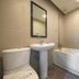 JK Hotel Busan bathroom with bathtub, pedestal sink, toilet, and wall mirror