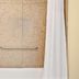 Super 8 by Wyndham Jacksonville Orange Park bathroom with tub, grab bar and shower curtain
