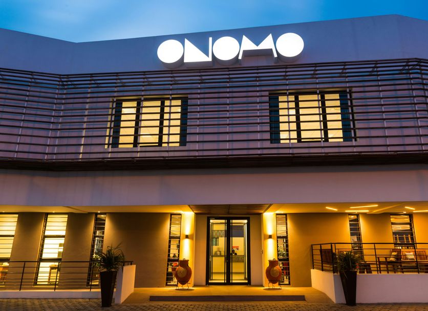 Onomo Hotel Lome in Lomé exterior at dusk with illuminated facade and entrance