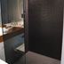 Valentine On George Sydney bathroom shower with glass door and dark tiled walls