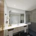 Vila Gale Porto bathroom with double sink vanity, walk-in shower, and glass partition in Porto