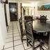 Mar Paraiso Queen in Acapulco dining area with round table, carved chairs and tiled floor