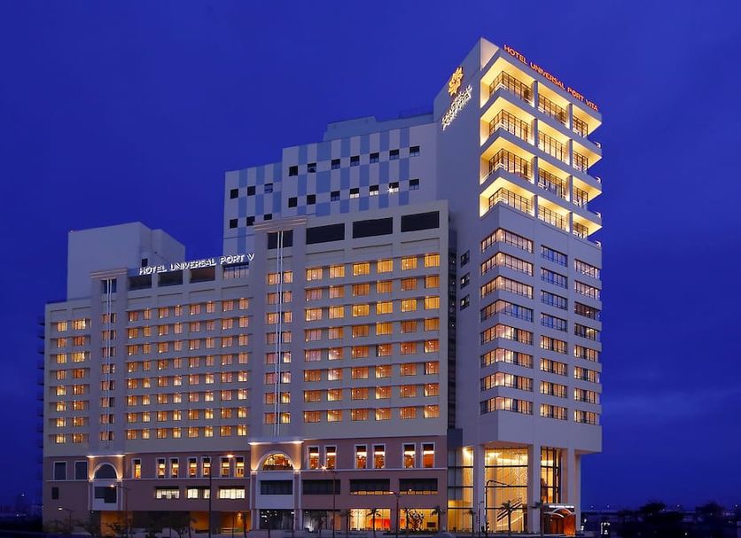 Hotel Universal Port Vita in Osaka at night, showing the illuminated high-rise hotel exterior