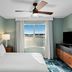 WorldMark Lake of the Ozarks bedroom with lake view, king bed, ceiling fan, and TV in Osage Beach