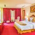 Sai Gon Rach Gia Hotel room in Rach Gia with king bed, red carpet, and large curtained window