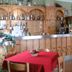 Hotel Meublè Adler bar and dining area with wooden counter and red tablecloth in Santa Caterina Valfurva