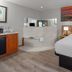Days Inn by Wyndham Mason City room with king bed, soaking tub and sunset wall art