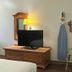 Motel 6 Portland, IN guest room with TV, dresser, ironing board, chair, and microwave