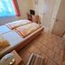 Zur Rotenfelsstube in Norheim guest room with twin beds, desk, window, and tiled floor