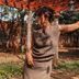 Vijayshree Resort, Hampi in Hosapete: woman posing under a shaded pergola in a garden