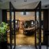 Grids Premium Hotel Osaka Namba in Osaka entrance to a warm wood-paneled dining area with long table