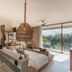 Soulshine Bali Ubud suite with woven pendant lights, lounge seating and balcony jungle view