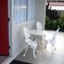 Midtown Motor Inn Whanganui patio with red door, white table and chairs