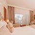 Venosa Beach Resort And Spa Didim guest room with king bed, TV, desk, and balcony view
