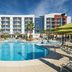 SpringHill Suites by Marriott Orange Beach at The Wharf pool and palm-lined courtyard in Orange Beach