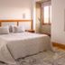 Hotel Rural Casa de Samaioes in Chaves bedroom with double bed, wood floors and window seat