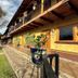 Huerta Real Mazamitla in Mazamitla, with yellow lodge exterior, balcony, garden, and stone courtyard