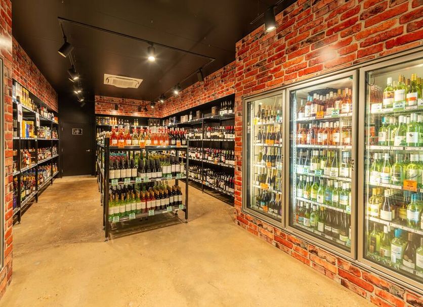 The Continental Hotel, Broome liquor store with glass-door coolers and shelves of wine and spirits