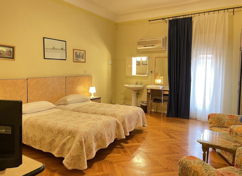 Hotel Panorama Bologna Centro room in Bologna with twin beds, parquet floor, and balcony curtains
