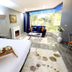 Çetinel Otel in Adana guest room with large bay window, seating area, fireplace, and patterned rug