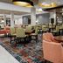 Hilton Garden Inn Chandler Downtown lobby lounge with tables, chairs, and a bar area in Chandler.