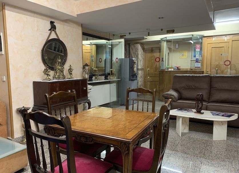 Hostal Juan XXIII in San Sebastián de los Reyes lobby lounge with tables, chairs and a sofa