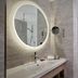 DoubleTree by Hilton Hull bathroom with lit round mirror, sink and framed whale-tail art