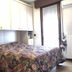 Casa Perlar Verona guest room with floral bedspread, built-in cabinets and balcony door