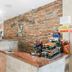 Paradise Oceanfront by Hbh front desk with brick accent wall in Hollywood