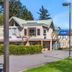 Motel 6 Surrey BC exterior with a covered driveway, trees, and clear blue sky in Surrey.