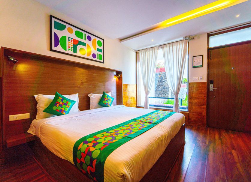 Treebo Tranquil Heights in Kodaikanal, bright guest room with king bed, window view and wooden flooring