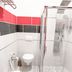 Hotel Le Cinéma Gatteo bathroom with glass shower, wall-mounted toilet and red accent tiles