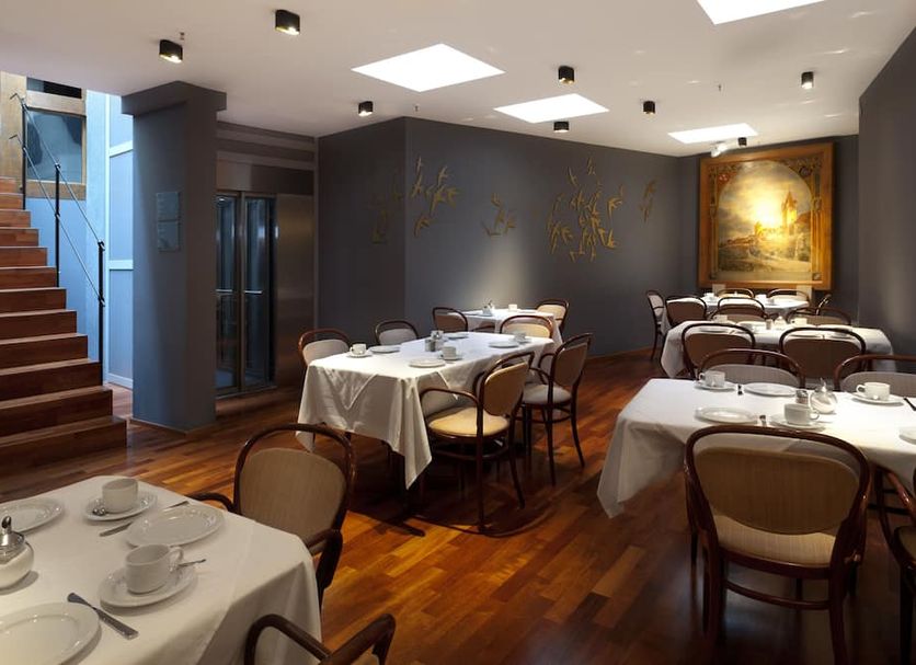 Dormero Hotel Schwäbisch Hall restaurant with set tables, wood floors and staircase in Schwäbisch Hall