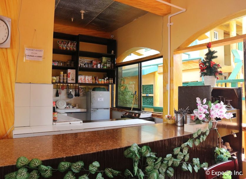 La Isla Bonita Resort in Boracay reception desk with clock, shelves, and tropical courtyard view