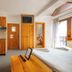 Penzion Snezienka room in Tatranska Lomnica with bed, kitchenette, wood furniture and balcony door