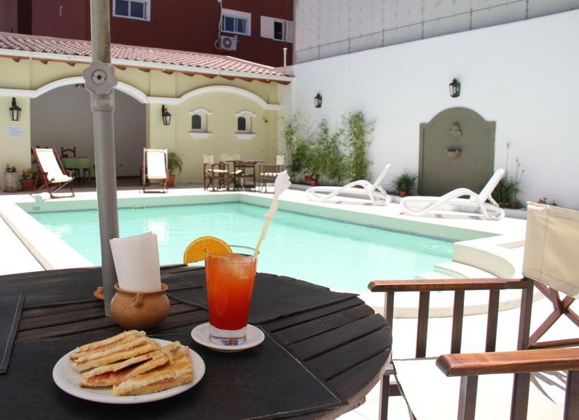 Altos De Balcarce Hotel, Salta: courtyard pool with loungers and a drink on a table