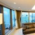 Marianne Hotel Busan lounge with sectional sofa and floor-to-ceiling windows overlooking the city