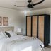 The Oaks Ranch in Mossy Point bedroom with king bed, bedside lamps, ceiling fan and wardrobe