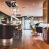Hotel & Spa Savarin in Rijswijk bar and lounge with high stools, wooden floors, and soft lighting