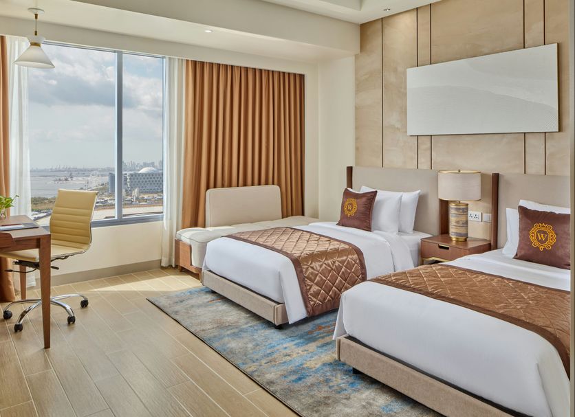 Grand Westside Manila Bay, Manila: twin beds in a modern room with city and bay views