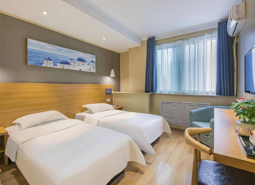 Super 8 by Wyndham Beijing Xi Zhi Men guest room with two single beds and window seating in Beijing