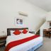 Fitzherbert Regency Motor Lodge in Palmerston North, room with king bed, dining table and kitchenette