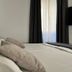 Villa Olivia, Split: close-up of a neatly made bed beside a window with black curtains