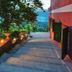 Agriturismo Cerrolungo in La Spezia, hillside terrace path with garden lights and valley view